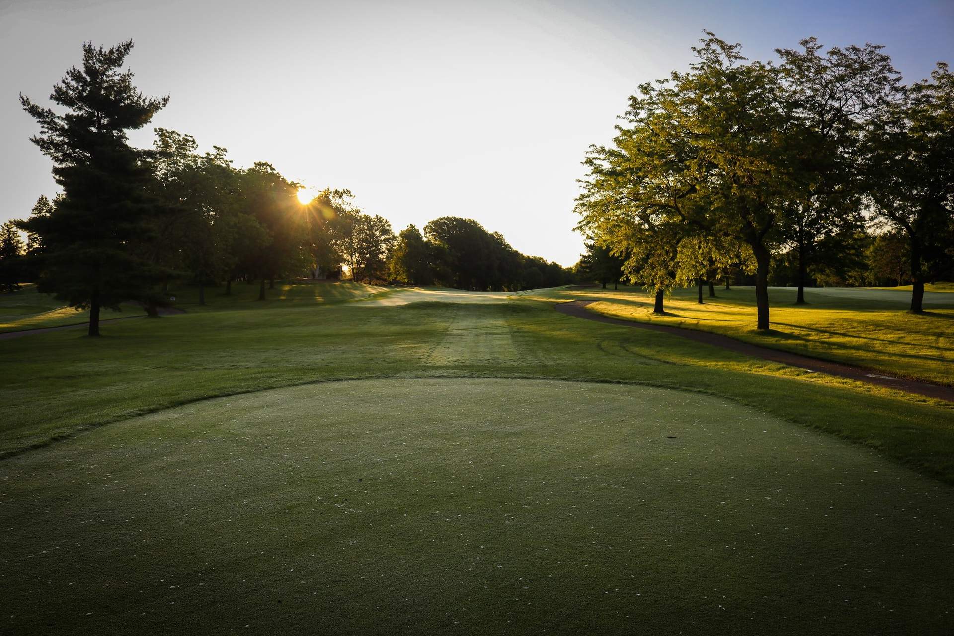 View of the tee box looking off into the sunshine.